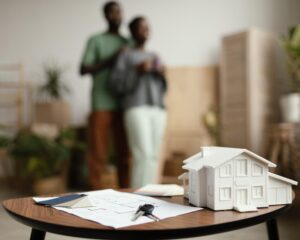 new-home-keys-plan-table-with-defocused-couple